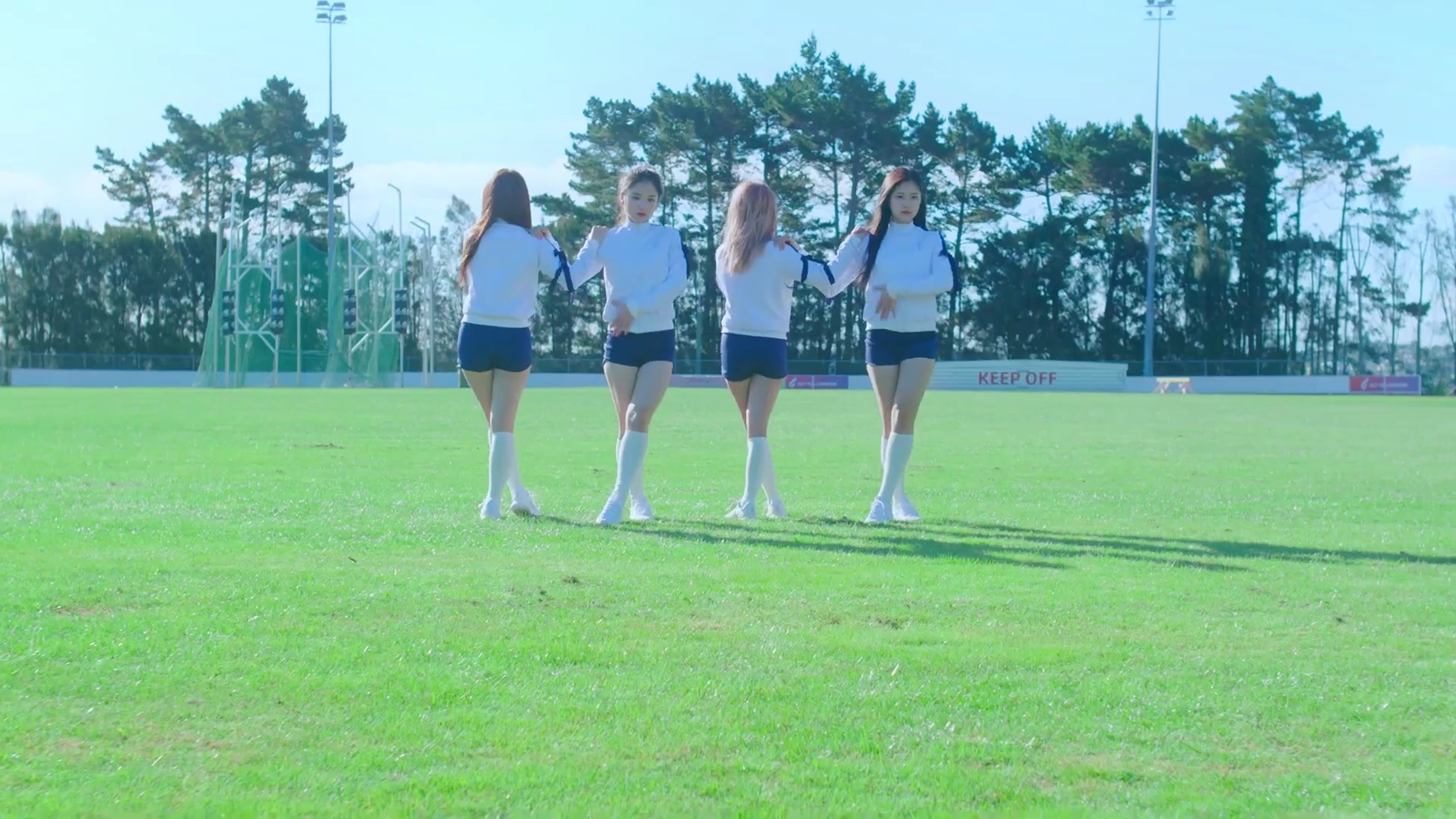 Loona One Third dancing in the middle of a track field.